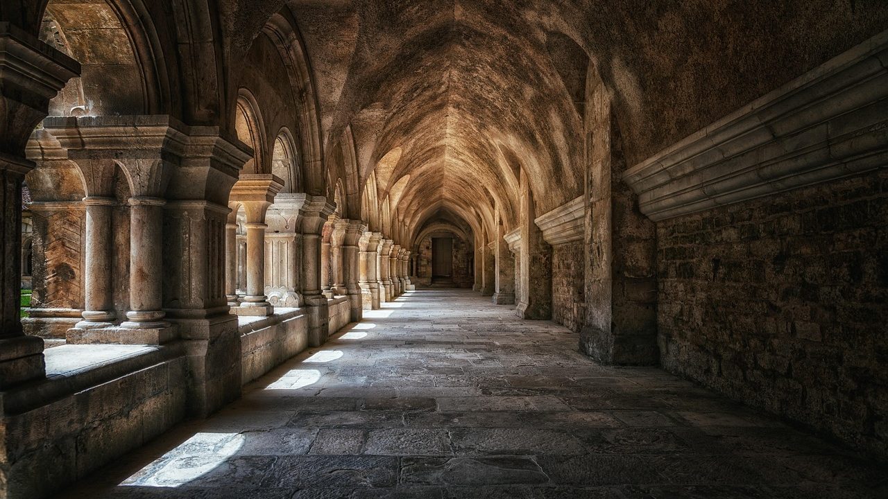 A vaulted stone cloister in low light — a database only as secure as the walls built around it.