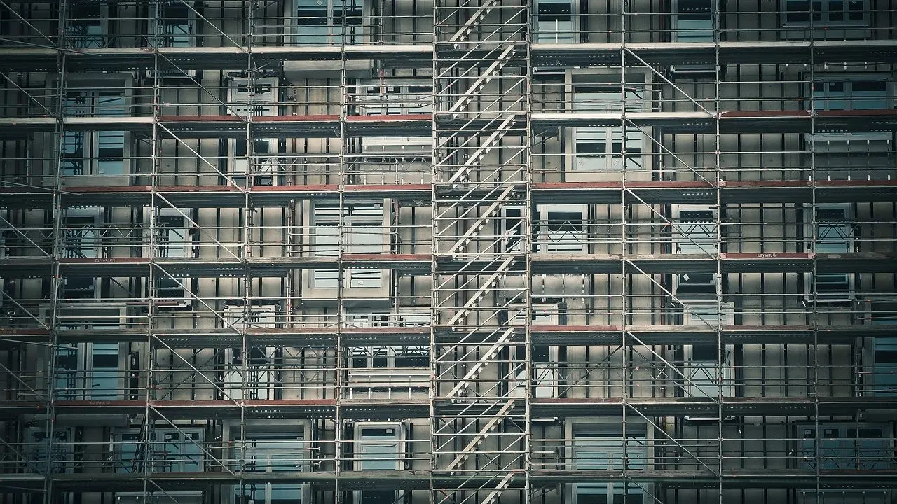 A half-built structure lit at night — an app generated fast, with the doors not yet locked.
