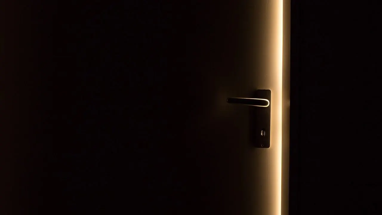 An open door spilling light into a dark room — a database left reachable without its access rules set.