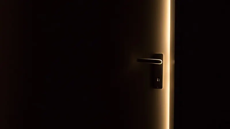 An open door spilling light into a dark room — a database left reachable without its access rules set.