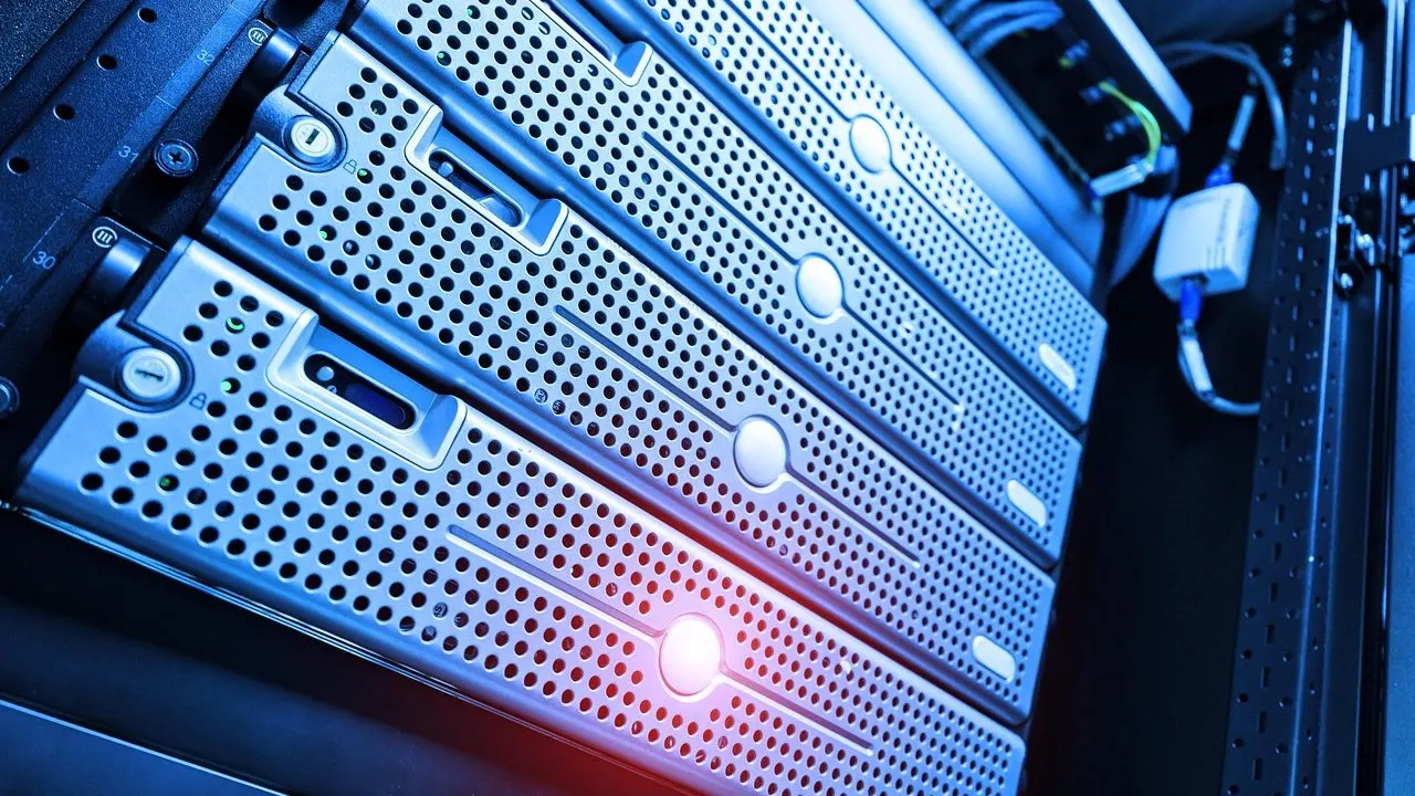 Blue-lit server blades in a rack, one glowing red — free-tier services idling between requests.