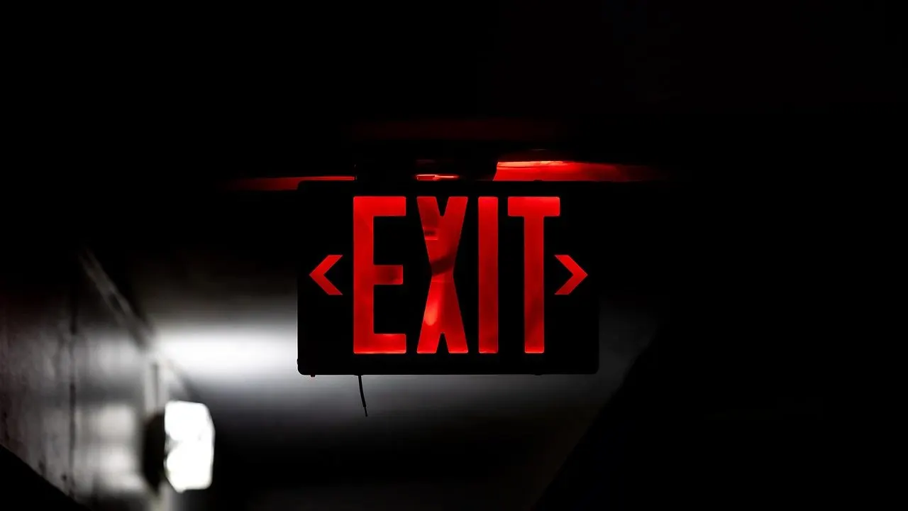 A red emergency light glowing in the dark — the moment a site goes down.