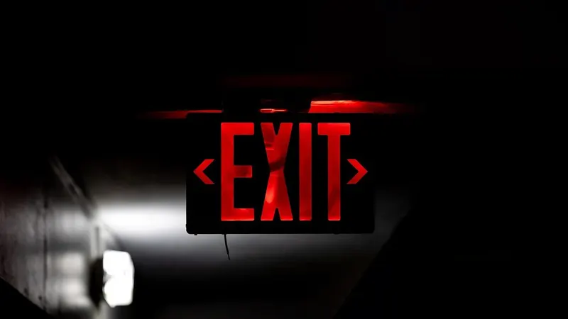 A red emergency light glowing in the dark — the moment a site goes down.