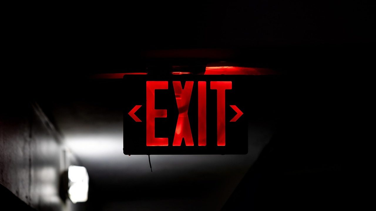 A red emergency light glowing in the dark — the moment a site goes down.