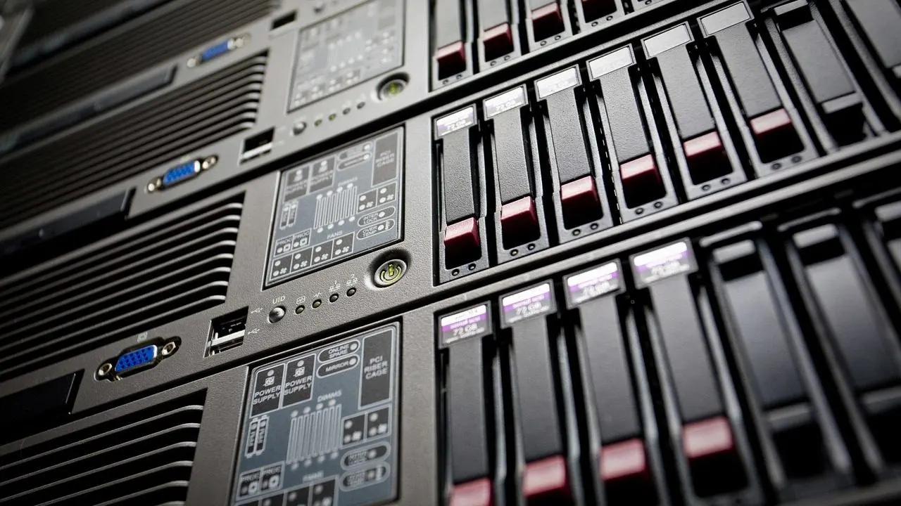A single dim server light in a dark rack — a free service idling, spun down and waiting for a request.