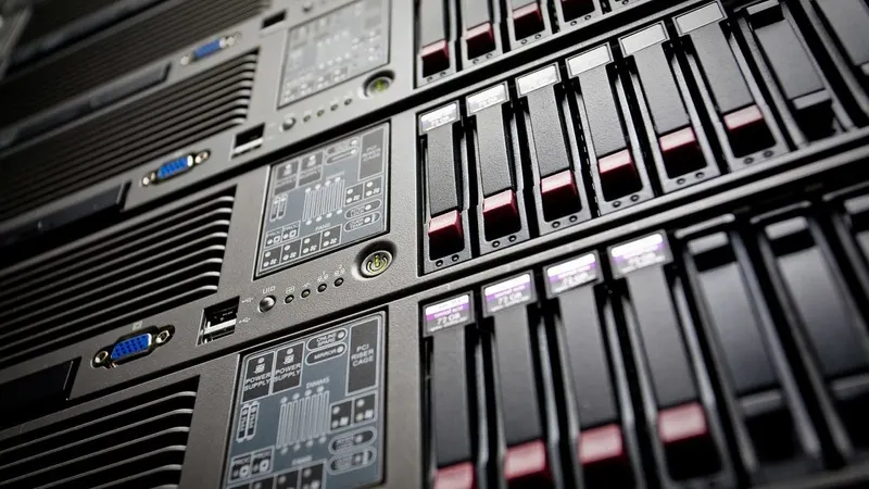 A single dim server light in a dark rack — a free service idling, spun down and waiting for a request.
