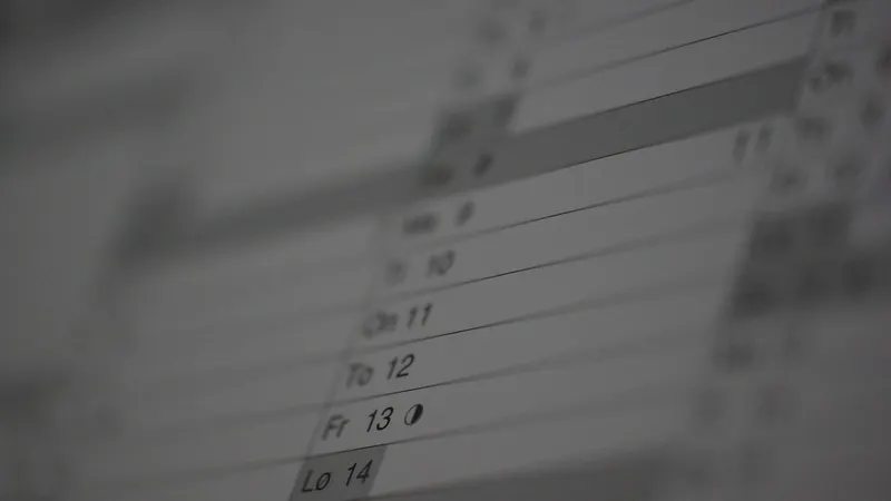 A calendar page fading into shadow — expiry dates arriving faster than a manual reminder can track.