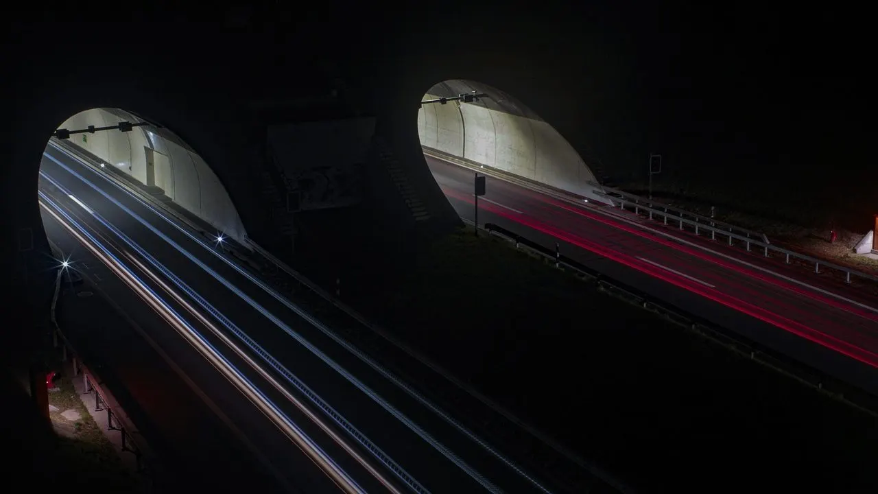 Light trails through a dark underpass at night — compute scaling to zero between queries.