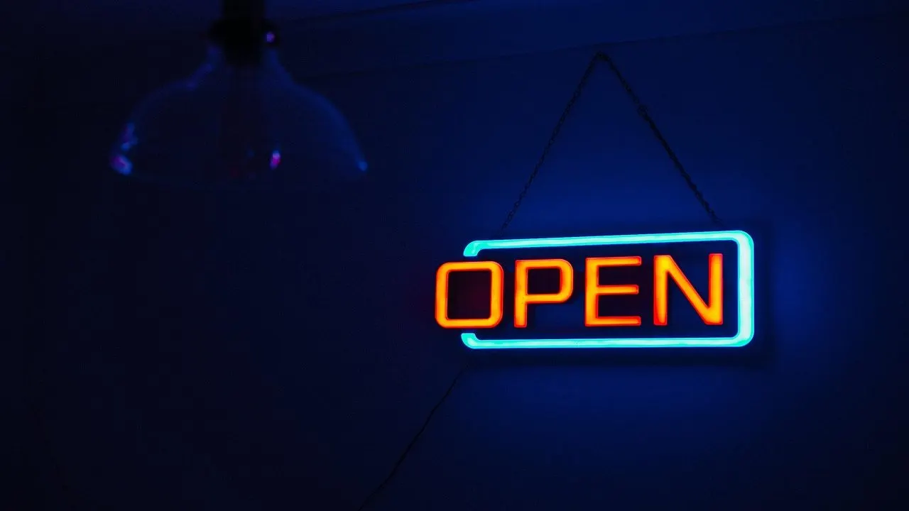 A glowing neon "OPEN" sign in the dark — a database left open to anyone who holds the public key.