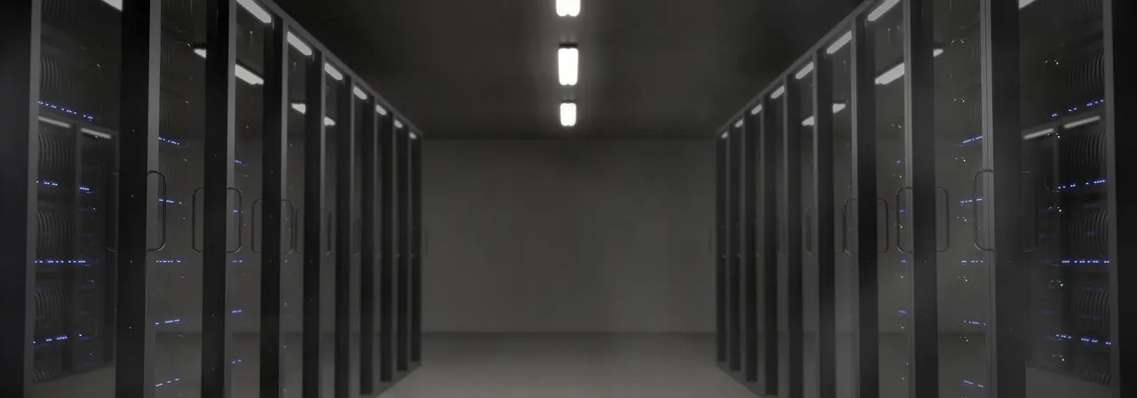 A dark, quiet server room — the kind of infrastructure a paused project leaves idle.