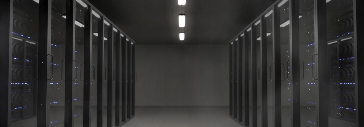A dark, quiet server room — the kind of infrastructure a paused project leaves idle.